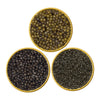Three round containers filled with different types of beluga caviar on a white background