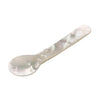 White mother of pearl spoon on a white background