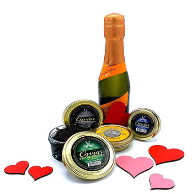 Bottle of wine and jars with heart-shaped decorations on a white background